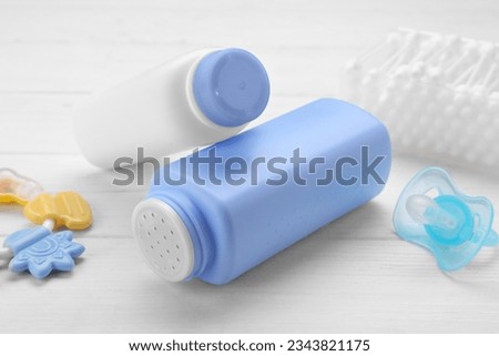 Baby powder, pacifier and cotton buds on white wooden table, closeup Royalty-Free Stock Photo #2343821175