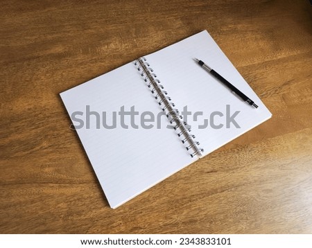 Notepad, pencil on the desk. Mock up in copy space office background. It is important not to forget the note