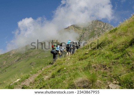 a group of tourists is walking along a mountain trail.hiking.people in the mountains.