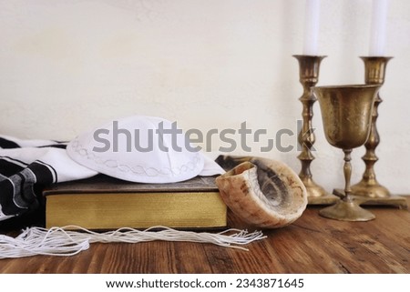 religion image of shofar (horn) on white prayer talit. Rosh hashanah (jewish New Year holiday), Shabbat and Yom kippur concept Royalty-Free Stock Photo #2343871645