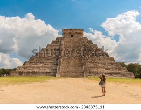 Traveler takes a photo of Pyramid in Chichen Itza, Temple of Kukulkan. Yucatan, Mexico Royalty-Free Stock Photo #2343875111