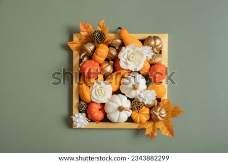 Golden frame with pumkins, roses and maple leaves. Autumn minimalist aesthetic concept.