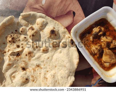 picture of pakistan traditional food, one portion of chicken karahi and one nan 