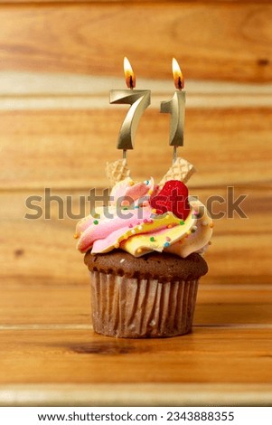 Golden birthday candle on wooden background - Birthday cupcake with numbered candle