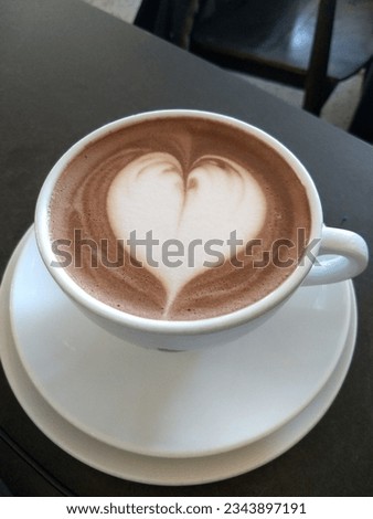 Hot chocolate with foam heart in mug
