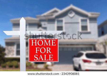 Home For Sale Real Estate Sign and Beautiful New House