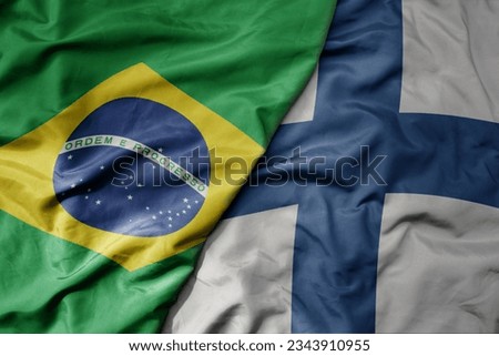 big waving realistic national colorful flag of brazil and national flag of finland . macro