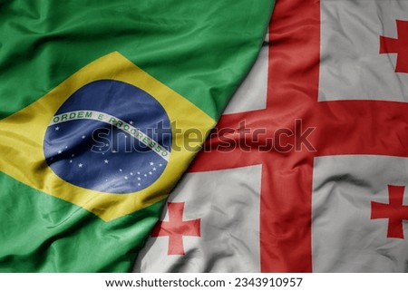 big waving realistic national colorful flag of brazil and national flag of georgia . macro
