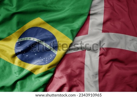big waving realistic national colorful flag of brazil and national flag of denmark . macro