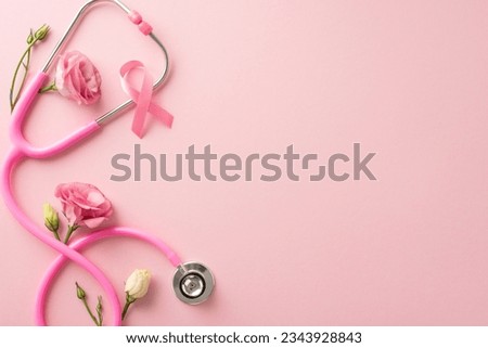 Remember the cause this International Breast Cancer Awareness Month. Top view photo of satin pink ribbon with fresh eustoma flowers on pastel pink isolated background, suitable for text or advertising Royalty-Free Stock Photo #2343928843
