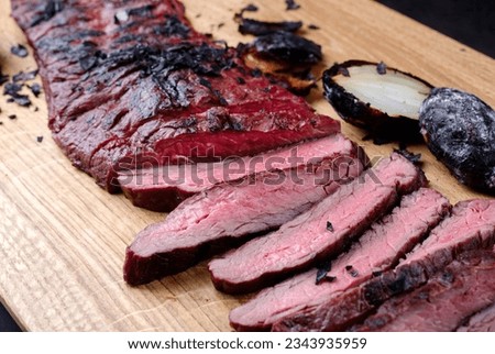 Traditional barbecue wagyu gourmet flank steak served as close-up on a modern design wooden board  Royalty-Free Stock Photo #2343935959