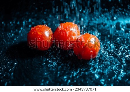Tomatoes drops into water surface