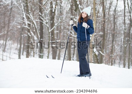 Portrait of Brunette young woman with ski in winter time