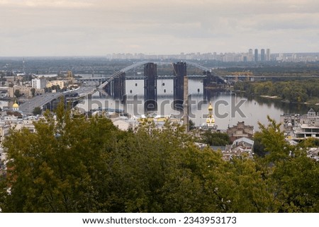 View from the hill to the Dnieper River and the bridge under construction from the right bank to the left, Kyiv, Podil, Ukraine.