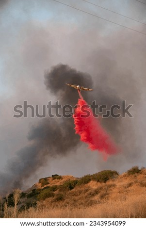 Cal Fire Plane Dropping Phos-Check At Rabbit Brush Fire Royalty-Free Stock Photo #2343954099