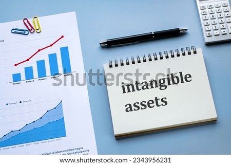 There is notebook with the word intangible assets. It is as an eye-catching image. Royalty-Free Stock Photo #2343956231