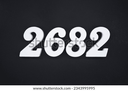 Black for the background. The number 2682 is made of white painted wood.