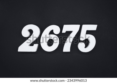 Black for the background. The number 2675 is made of white painted wood.