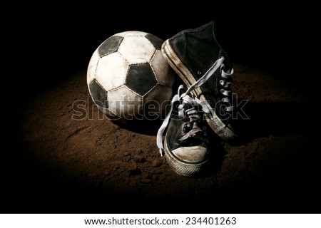 Soccer ball on ground on dark background