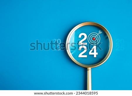 Happy new year 2024 with business concept banner. The big white 2024 year number with Target icon inside the golden magnifying glass on light blue background. Planning for goal and success concepts. Royalty-Free Stock Photo #2344018595