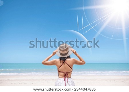Asian model wear red swimsuit and straw hat stand on beach look view on hot day, Sun and UV rays hit the beautiful woman's protective layer. concept about of spa, sunscreen, cosmetics, health. Royalty-Free Stock Photo #2344047835