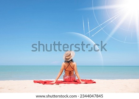 Asian model wear red swimsuit and straw hat sit on beach look view on hot day, Sun and UV rays hit the beautiful woman's protective layer. concept about of spa, sunscreen, cosmetics, health. Royalty-Free Stock Photo #2344047845