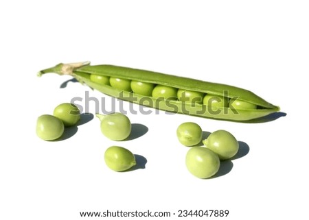 On a white background lie several pods of green peas with peas.