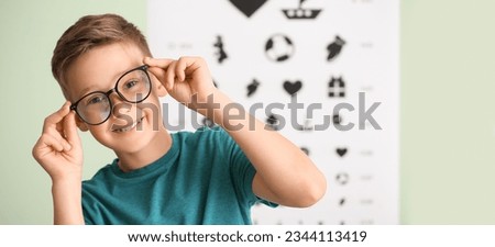 Little boy wearing glasses at ophthalmologist's office Royalty-Free Stock Photo #2344113419