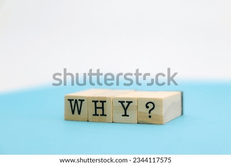 the word "why?" on wooden cubes