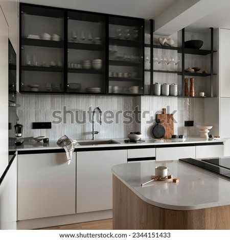 Interior design of modern kitchen space with gray cabinets, simple silver faucet, wooden floor, cutting board, fruit bowl, wine glasses, and kitchen accessories. Home decor. Template. 