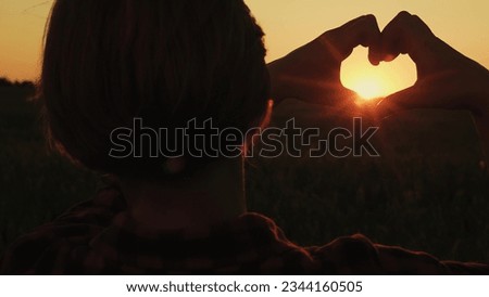 Her mind heart flowing happiness freedom, chasing dream basks orange glow sunset sky. romantic concept love beautifully shaped she holds hands with her valentine, making gesture shows symbol love park