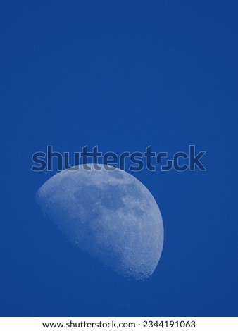 Big moon on blue sky background, in the morning