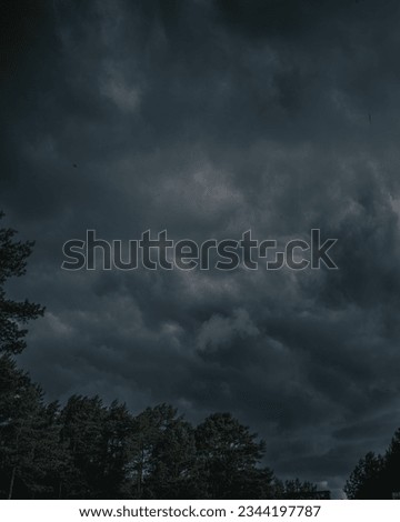 Storm approaching with dark blue clouds and lightning