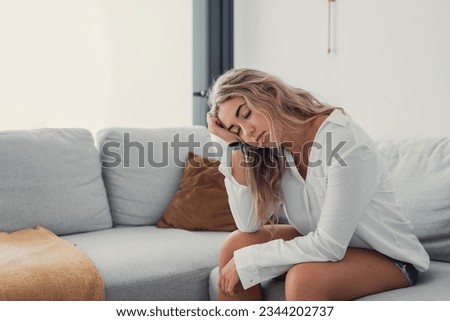 Depressed or tired teen girl feeling stress headache hurt pain sitting alone at home, upset sad heartbroken young woman regret pregnancy or abortion, troubled with problem or psychological trauma
 Royalty-Free Stock Photo #2344202737
