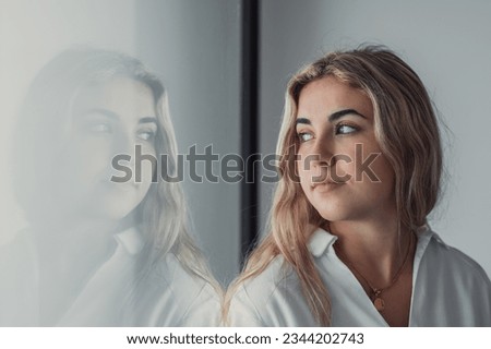 Unhappy thoughts. Worried young caucasian woman look at window feel lonely sad wait for boyfriend coming back after quarrel. Pessimistic millennial lady hide from life problems at home. Copy space Royalty-Free Stock Photo #2344202743
