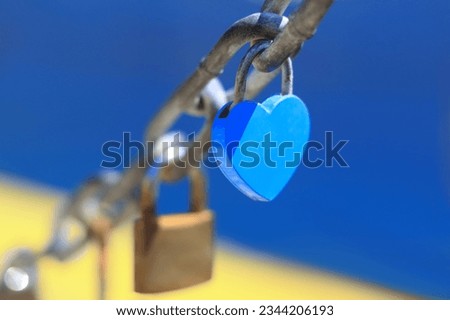 Blue heart shaped padlock as symbol of eternal love hanging on chain with sea view. Old rusty love locks on chain. Vintage colorful padlocks heart shaped on blue background. Couple. Clip art. Cards