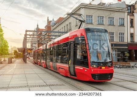Red modern tram in the center of Katowice, Poland Royalty-Free Stock Photo #2344207361