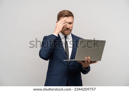 Frustrated businessman with laptop in hands. Worried trader man failed on stock exchange failed in trading, falling sales, business collapse, difficulties financial problems, burnt investments Royalty-Free Stock Photo #2344209757