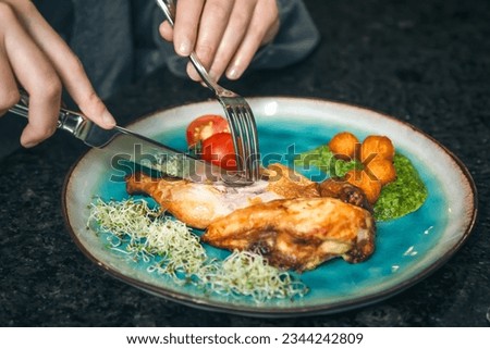 Chicken with vegetables on a plate in a cafe.