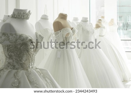 Beautiful wedding bridal dresses on mannequin in showroom in mall. Royalty-Free Stock Photo #2344243493