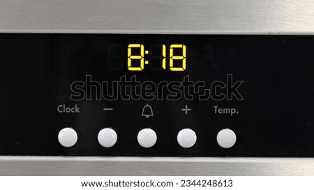Digital clock and controls on an electric oven Royalty-Free Stock Photo #2344248613