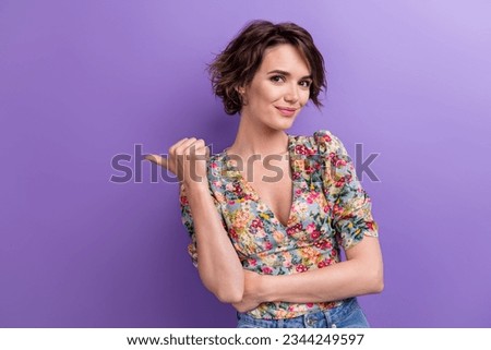 Photo of positive adorable lady wear trendy blouse thumb demonstrates empty space cool offer isolated on purple color background