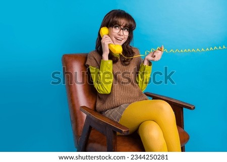 Photo of positive tricky lady wear brown vest spectacles siting chair answer table call looking empty space isolated blue color background Royalty-Free Stock Photo #2344250281