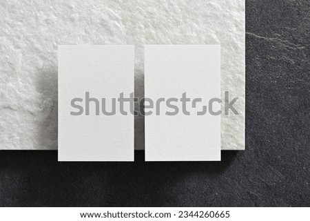 Elegant white luxury business card mockup, Clean and modern stationery template for two business cards laying flat on a white quartz stone