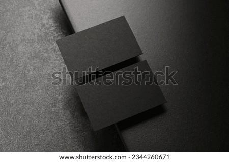Two real black business cards on elegant dark background, Empty template for luxury stationery mockup Royalty-Free Stock Photo #2344260671