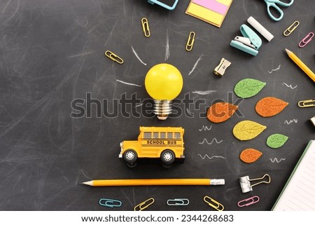 Back to school concept. bus and pencils over classroom blackboard. Top view