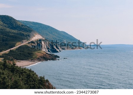 scenic route with cliffs and a blue ocean. picture taken in summer at the Cabot Trail in Nova Scotia, Canada. 