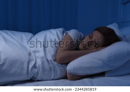 Beautiful woman sleeping in bed at night Royalty-Free Stock Photo #2344285819