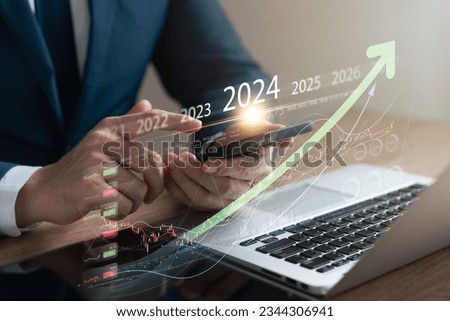 Explore the stock market trends for 2024 with analytical visuals of businessman planning long term investments and future business growth, Navigate towards success with smart strategies. Royalty-Free Stock Photo #2344306941