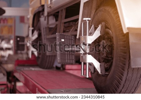 Car wheel clamp with wheel align device for wheel alignment truck tire in workshop Royalty-Free Stock Photo #2344310845